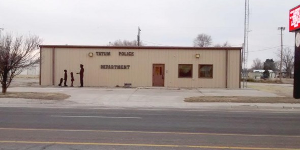 Police department building with a person standing outside.